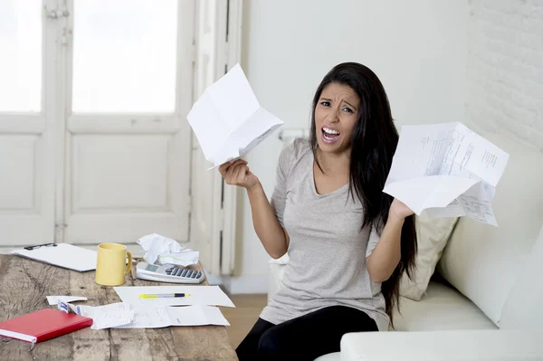 Young attractive latin woman at home living room couch calculating monthly expenses worried in stress — Stockfoto