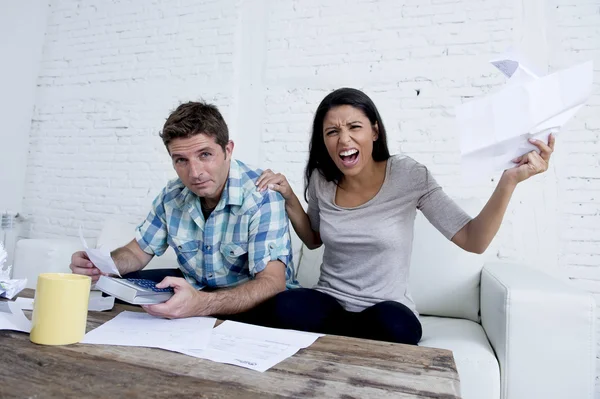 Young sad couple at home living room couch calculating monthly expenses worried in stress — Φωτογραφία Αρχείου