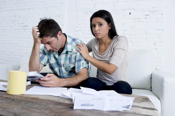 Young sad couple at home living room couch calculating monthly expenses worried in stress — Stok fotoğraf