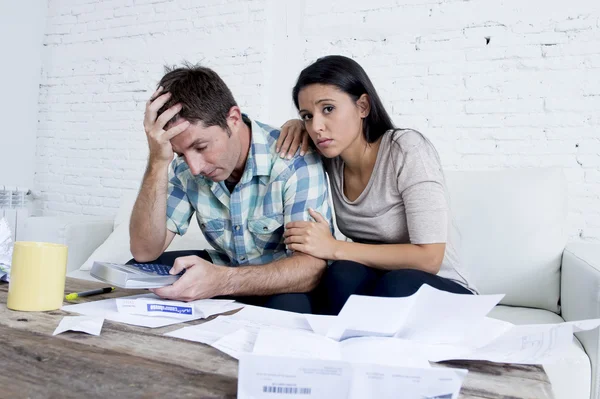 Young sad couple at home living room couch calculating monthly expenses worried in stress — Stock fotografie