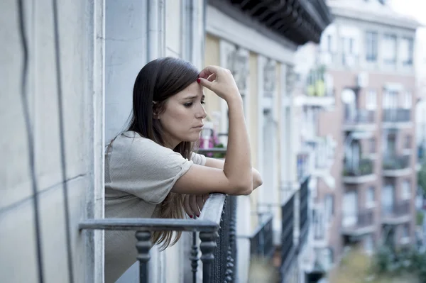 Joven triste hermosa mujer sufriendo depresión buscando preocupado y desperdiciado en casa balcón —  Fotos de Stock