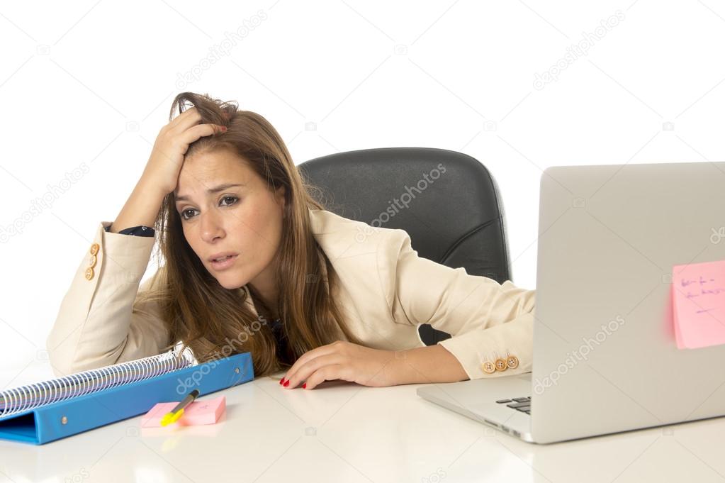 businesswoman suffering stress at office computer desk looking worried depressed and overwhelmed