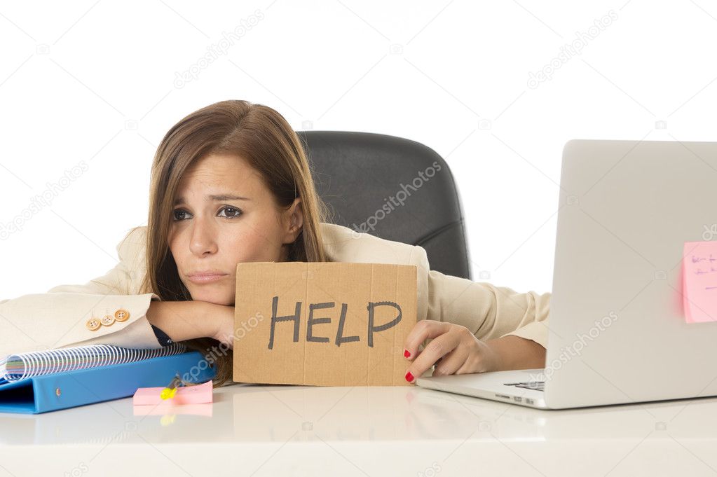 sad desperate businesswoman in stress at office computer desk holding help sign