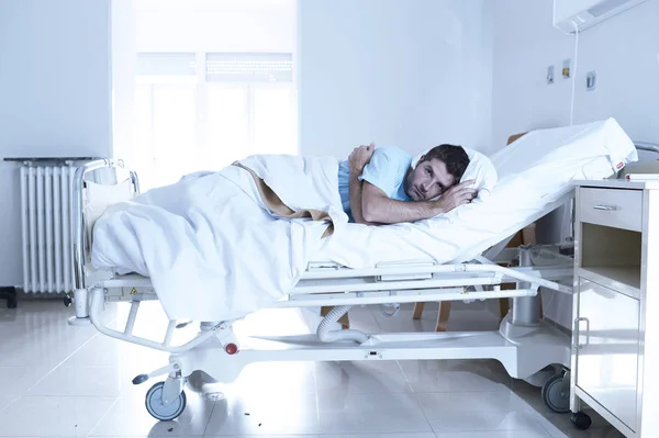 Desperate man at hospital bed alone sad and devastated suffering depression _ — Stockfoto