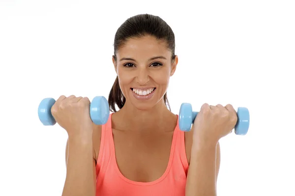 Beautiful and exotic hispanic woman holding hand weights training in fitness concept — Stock Photo, Image