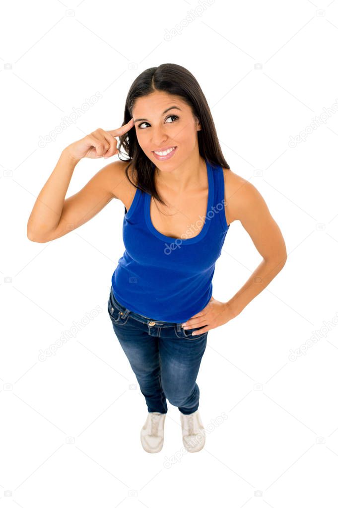 hispanic woman smiling happy in top and jeans pointing her head thinking