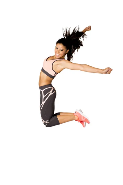 Genç çekici İspanyol fitness eğitmeni kadın yüksek heyecanlı ve mutlu atlama Stok Fotoğraf