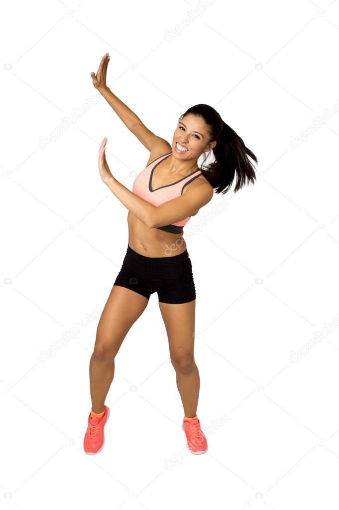 young beautiful latin woman in fitness clothes dancing zumba in aerobic workout happy and excited