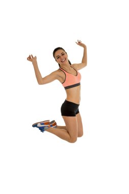 genç çekici fitness eğitmeni kadın yüksek heyecanlı ve mutlu atlama