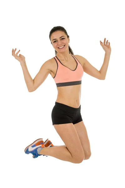 Young attractive fitness trainer woman jumping high excited and happy — Stock Photo, Image