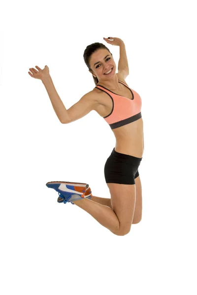 Young attractive fitness trainer woman jumping high excited and happy — Stock Photo, Image