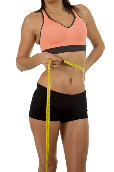 Sport woman holding measure tape showing slim perfect size abs and stomach — Stock Photo, Image