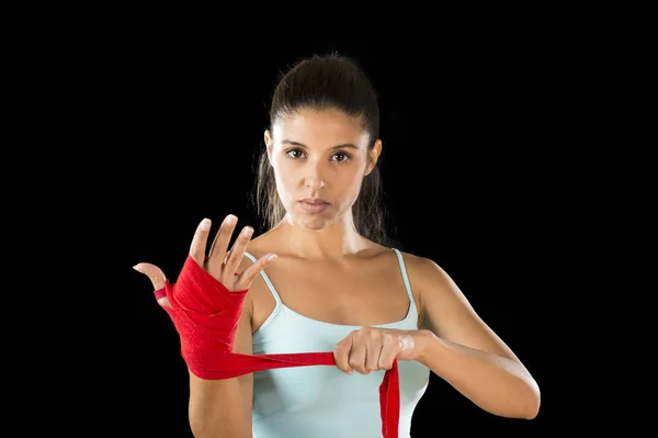 Attractive hispanic fitness woman doing self hand wraps before boxing or fighting workout — Stock Photo, Image