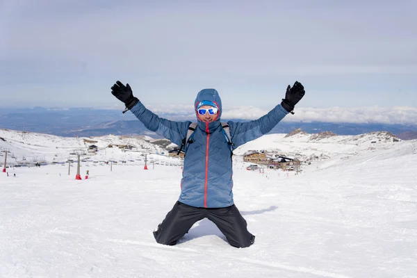 Man doing victory sign after peak summit trekking achievement in snow mountain on winter landscape Stock Picture