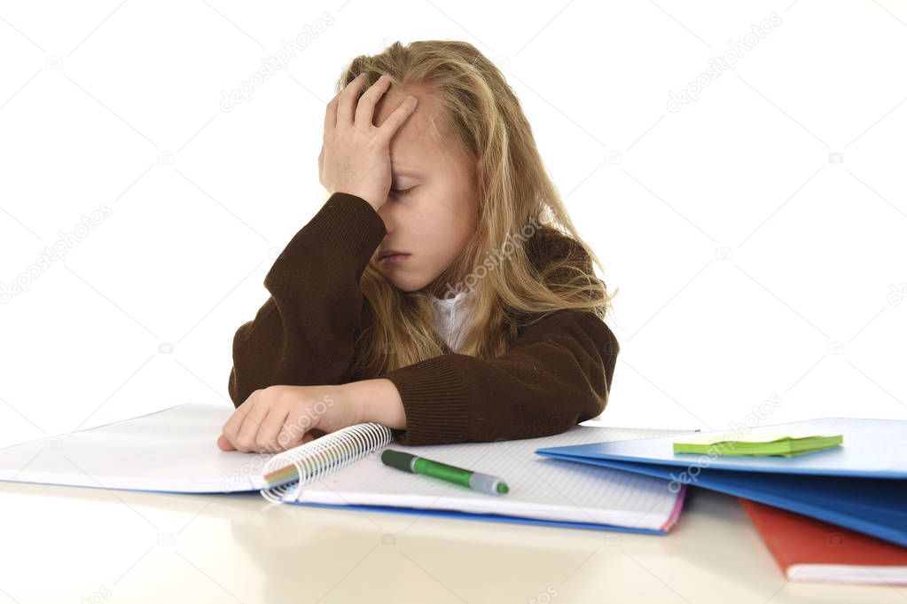  little schoolgirl sad and tired looking depressed suffering stress overwhelmed by load of homework