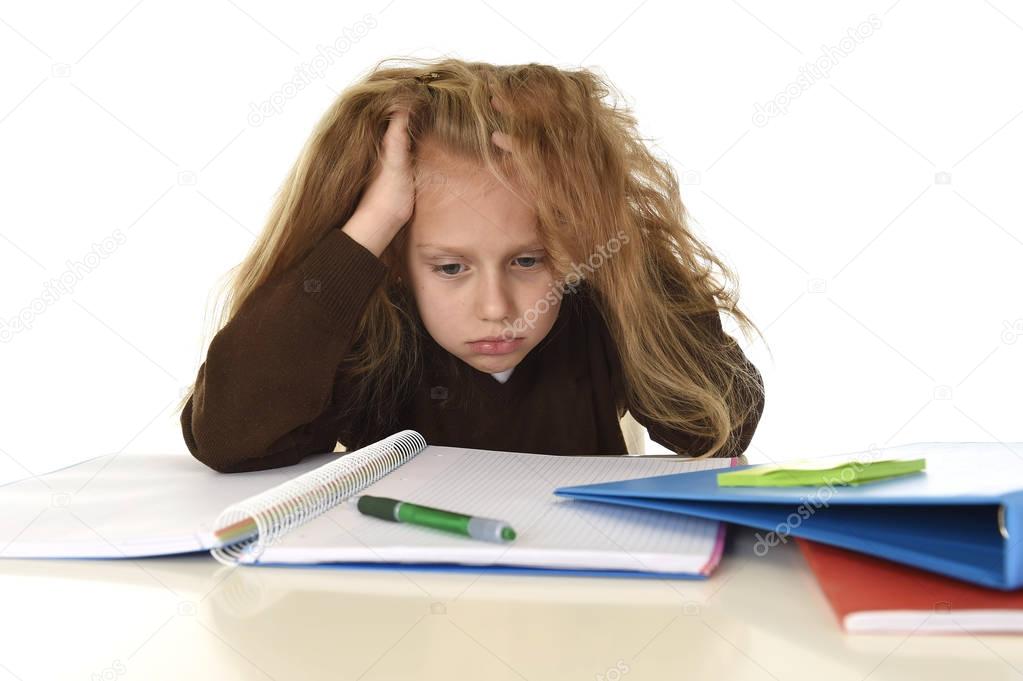  little schoolgirl sad and tired looking depressed suffering stress overwhelmed by load of homework