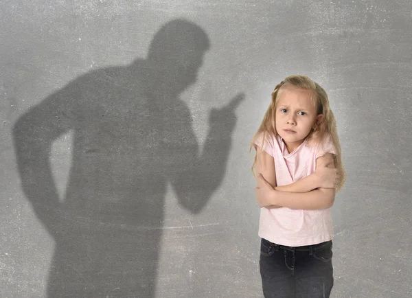 Father or teacher shadow screaming angry reproving young sweet little schoolgirl or daughter — Stock Photo, Image