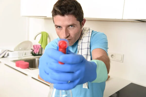 Young happy man holding washing detergent spray bottle as aiming with hand gun playful — Stock Photo, Image