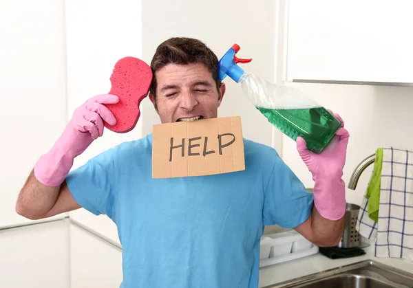 Messy man in stress in washing gloves holding sponge and detergent spray bottle asking for help — Stock Photo, Image