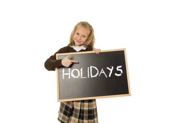 Schoolmeisje lachende gelukkig bedrijf en tonen schoolbord met tekst vakantie in einde van school — Stockfoto