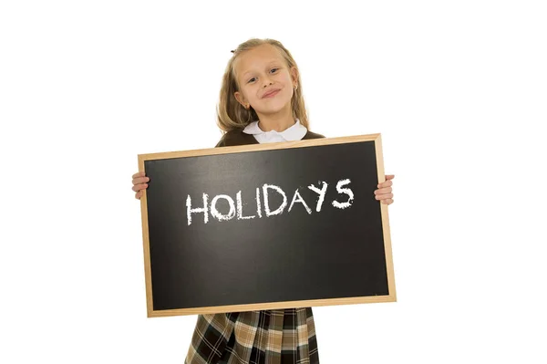 Schoolgirl smiling happy holding and showing blackboard with text holidays in end of school — Stock Photo, Image