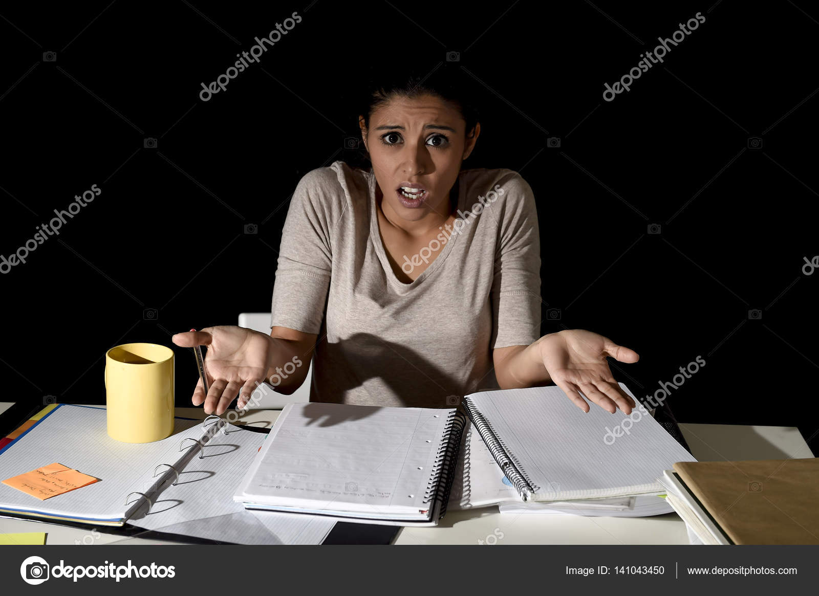 Spanish girl studying tired and bored at home late night looking sad ... Spanish girl studying tired and bored at home late night looking sad ...