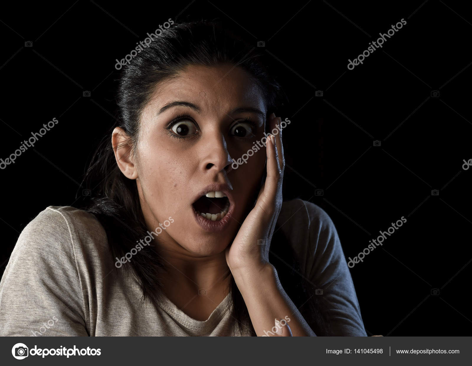 Shocking face in spanish Young beautiful scared Spanish woman in