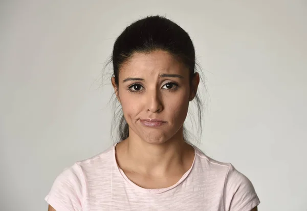 Young beautiful hispanic sad woman serious and concerned in worried depressed facial expression — Stock Photo, Image