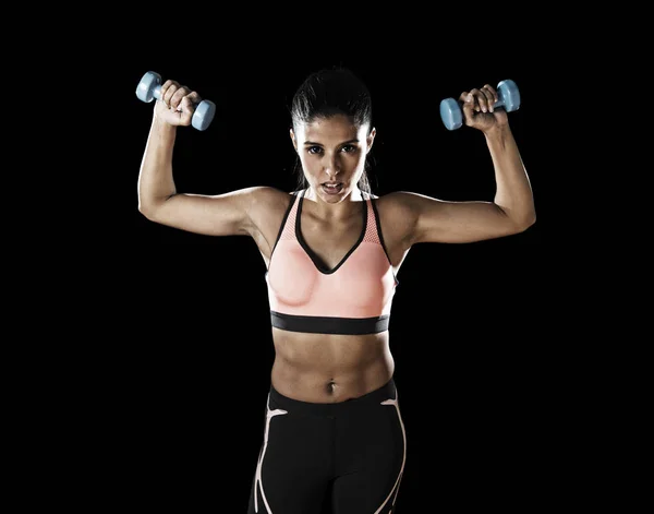 Latin sport woman posing in fierce expression holding dumbbell — Stock Photo, Image