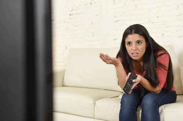 Young beautiful hispanic woman at home watching television tired and bored — Stock Photo, Image