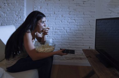 mutlu kadın kanepe koltuk mutlu adlı televizyon izlerken patlamış mısır yeme keyfini heyecanlı