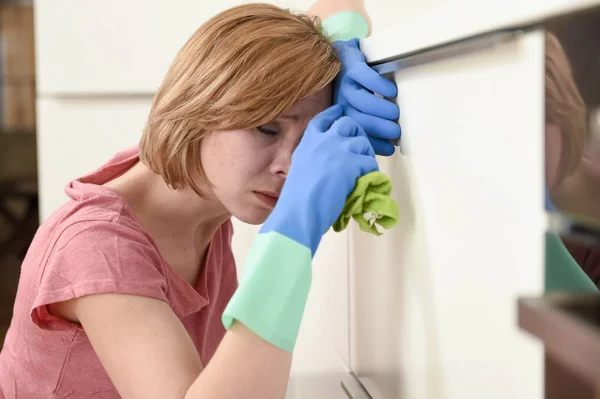 Woman on kitchen with rubber  washing gloves cloth and detergent cleaning bored and tired — Stock Photo, Image