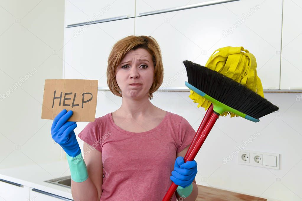 woman at home kitchen in gloves with cleaning broom and mop asking for help