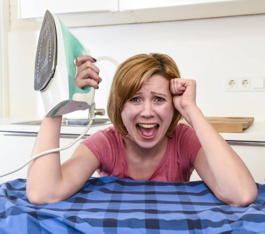 angry woman or crazy busy housewife ironing shirt lazy at home k clipart