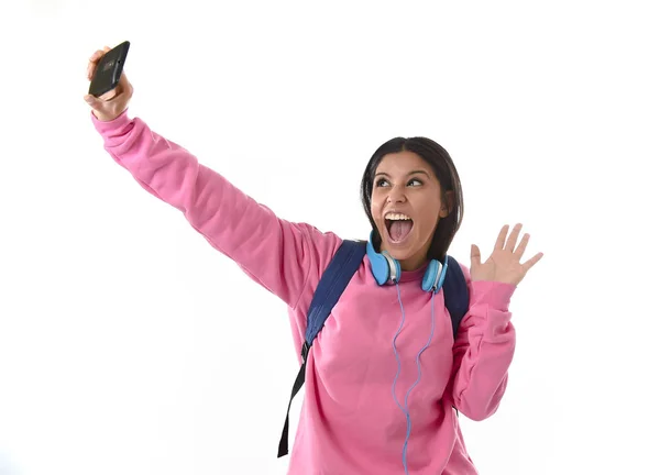 Attractive and happy woman or student girl with backpack and headphones taking selfie photo — Stock Photo, Image