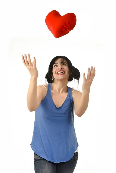 Beautiful woman smiling happy feeling in love throwing to air re — Stock Photo, Image