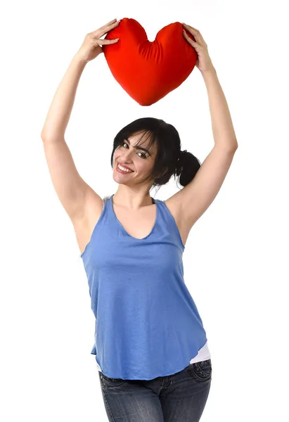 Beautiful woman smiling happy feeling in love holding red heart shape pillow — Stock Photo, Image