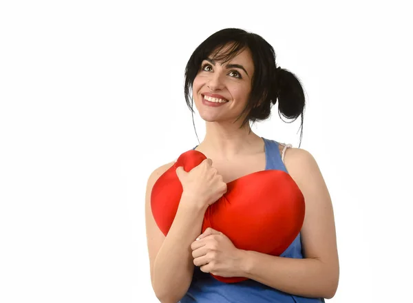 Attractive and beautiful woman smiling happy feeling in love holding red heart shape pillow — Stock Photo, Image