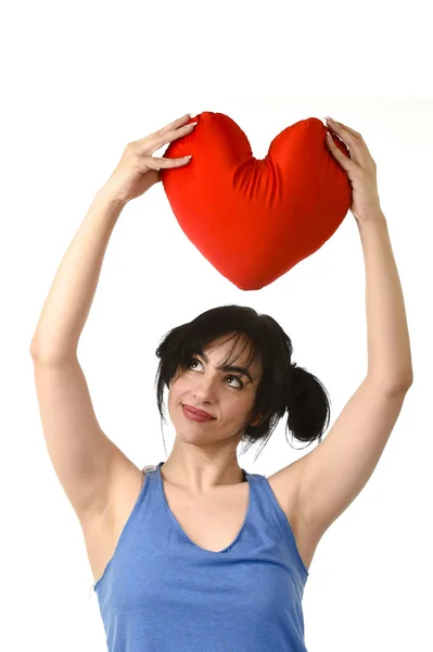 Beautiful woman smiling happy feeling in love holding red heart shape pillow — Stock Photo, Image