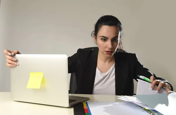 busy attractive woman in business suit working in stress desperate overwhelmed