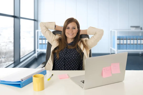 Attractive woman sitting at office chair working at laptop computer desk — Stock Photo, Image