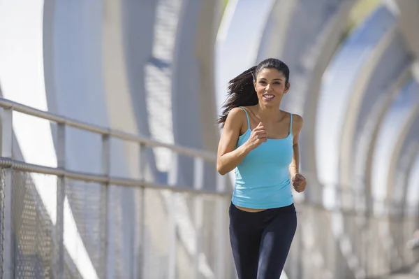Young beautiful athletic sport woman running and jogging crossing modern metal city bridge — Stock Photo, Image