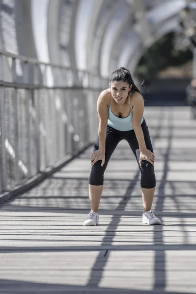 sport woman tired and exhausted breathing and cooling down after running