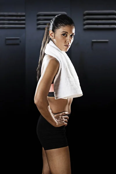 Attractive sexy latin sport woman posing with towel in fierce and badass face expression — Stock Photo, Image
