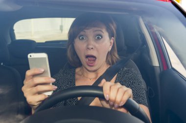 beautiful woman  driving car while texting using mobile phone distracted clipart