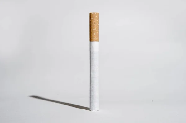 Cigarette and shadow isolated on white background in unhealthy h — Stock Photo, Image