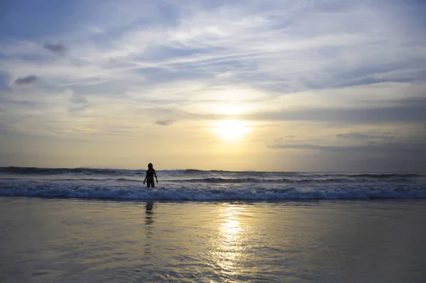 Young active woman on sea landscape sunset horizon with amazing sun and dramatic orange sky — Stock Photo, Image