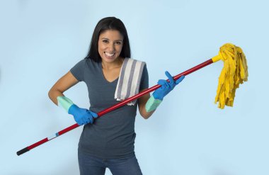 young attractive happy Latin woman in washing gloves holding mop having fun singing and playing air guitar excited  clipart