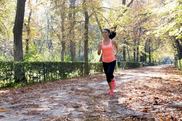 attractive and happy runner woman in Autumn sportswear running a