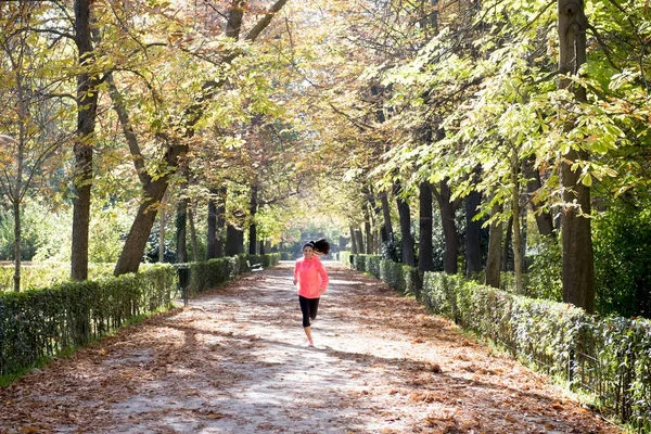 attractive and happy runner woman in Autumn sportswear running a